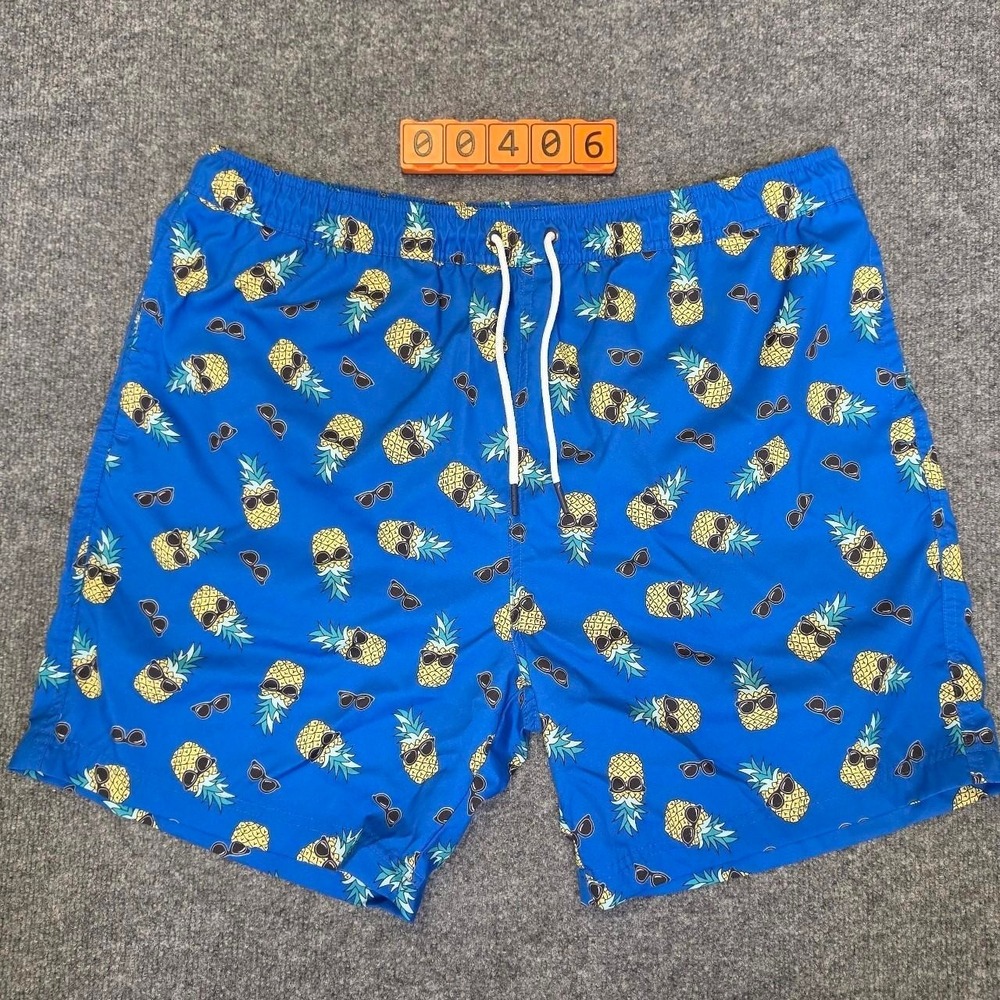 Berkley Jensen Blue Swim Trunks with Yellow Pineapples Wearing Sunglasses, XL.